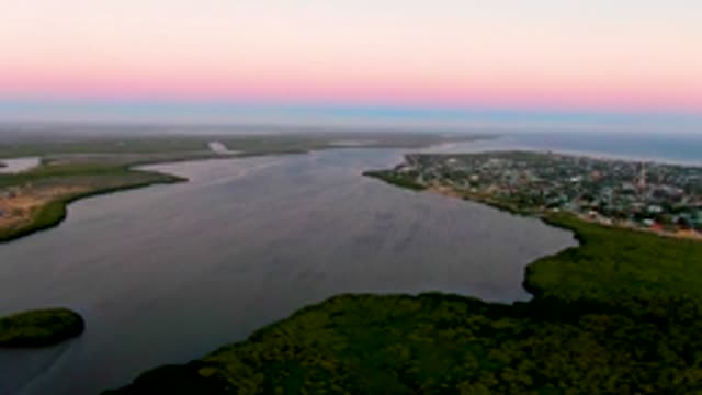 SAN CARLOS BCS MEXICO-2022: River and Town at Dusk with Passing Boat