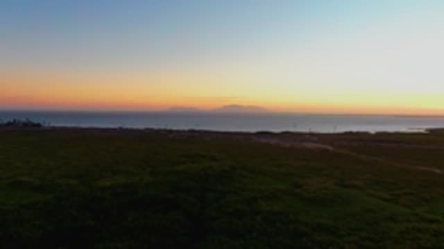 SAN CARLOS BCS MEXICO-2022: Coastal Grassland at Sunset with Ocean Horizon