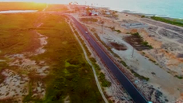 SAN CARLOS BCS MEXICO-2022: Coastal Road with Moving Vehicles at Sunset