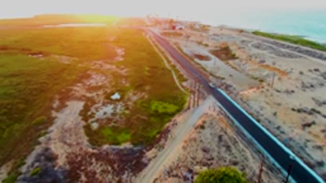 SAN CARLOS BCS MEXICO-2022: Car Driving on Coastal Road at Sunset