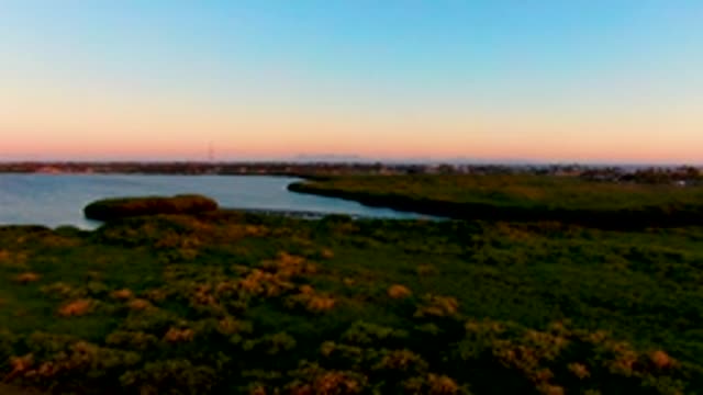 SAN CARLOS BCS MEXICO-2022: Sunset over a Small Bay and Grassy Shore