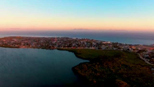 SAN CARLOS BCS MEXICO-2022: Coastal Town at Dusk with Lagoon and Hill