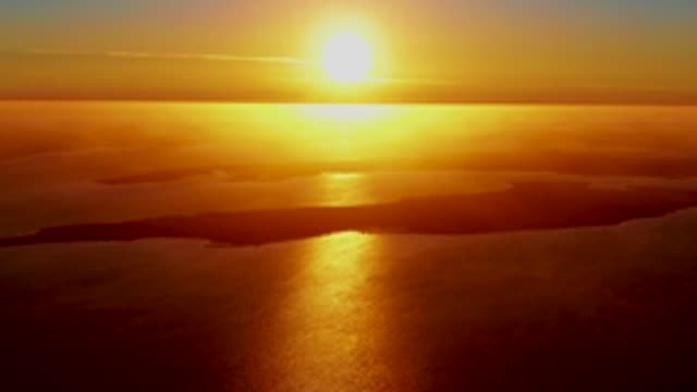 SAN CARLOS BCS MEXICO-2022: Sun's Golden Glow Over Cloudy Ocean Surface