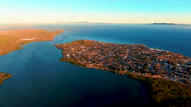 SAN CARLOS BCS MEXICO-2022: Boat Moving Through Coastal Inlet near Town