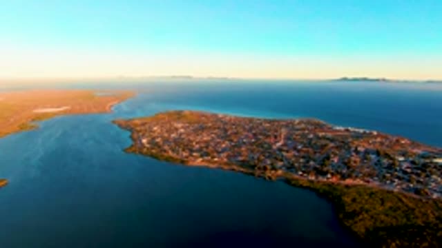 SAN CARLOS BCS MEXICO-2022: Coastal Town with Shifting Sunlight on Buildings