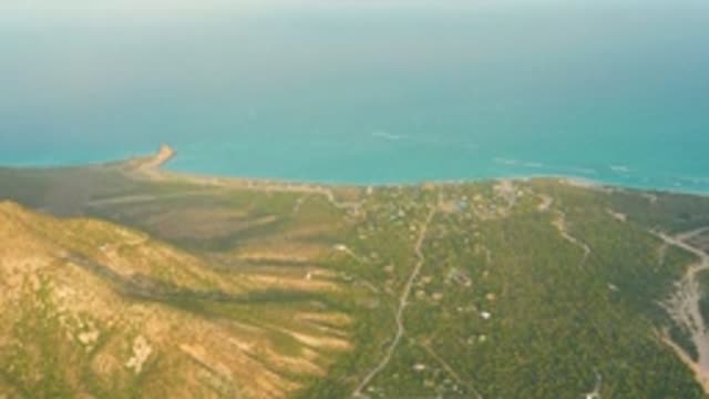 CABO PULMO LOS CABOS BCS MEXICO-2022: Hilly Coastline with Turquoise Sea and Scattered Buildings