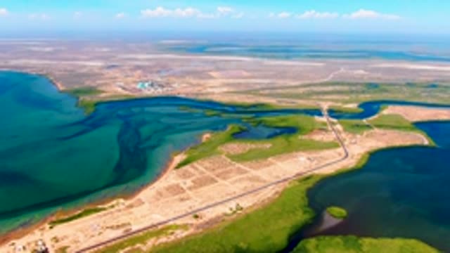 SAN CARLOS BCS MEXICO-2022: Vehicle Moving Along Coastal Road From Above