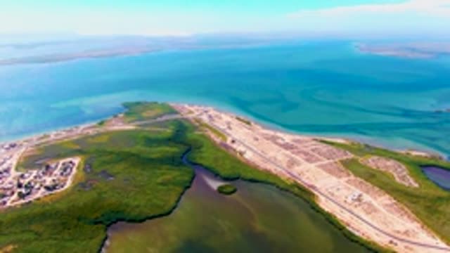 SAN CARLOS BCS MEXICO-2022: Coastal Runway Bordered by Lush Green and Calm Waters