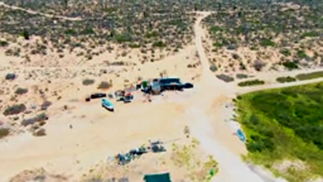 SAN CARLOS BCS MEXICO-2022: Boat Moving Across Sandy Desert Terrain