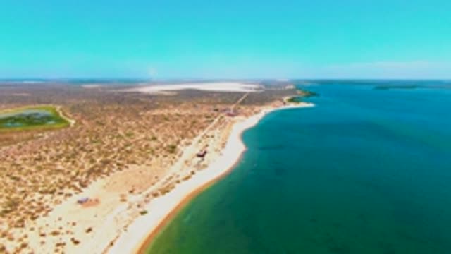 SAN CARLOS BCS MEXICO-2022: Vehicle Moving Along Sandy Beach Shore