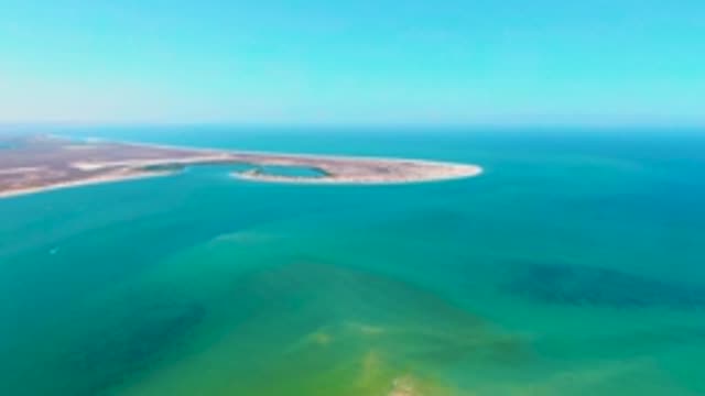 SAN CARLOS BCS MEXICO-2022: Coastal Sandbar and Boat Moving in Turquoise Waters