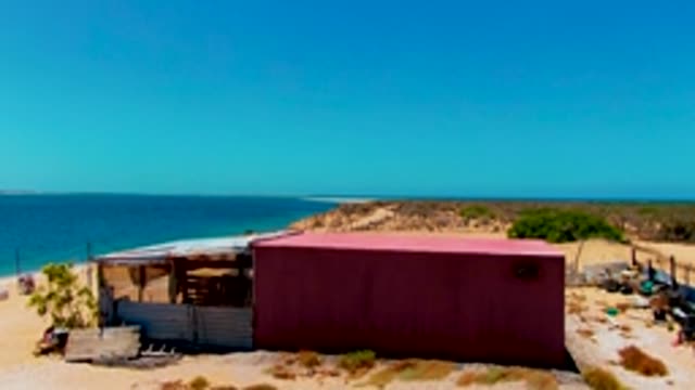 SAN CARLOS BCS MEXICO-2022: Beach and Red Container Receding From View