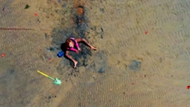 SAN CARLOS BCS MEXICO-2022: Child Playing in Wet Sand Then Departing Beach