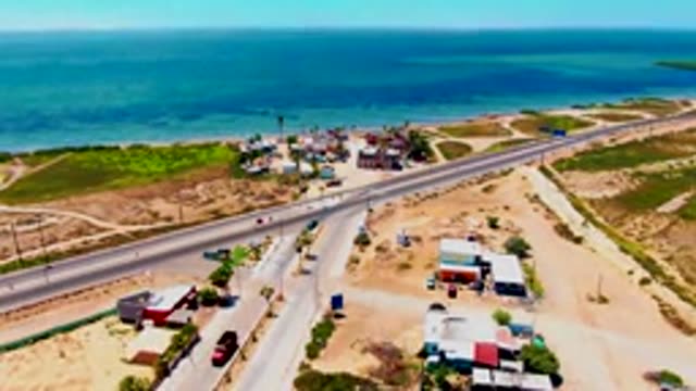 SAN CARLOS BCS MEXICO-2022: Coastal Highway Traffic and Ocean Shoreline