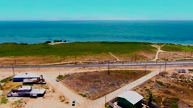 SAN CARLOS BCS MEXICO-2022: Coastal Road with Passing Car and Small Structures
