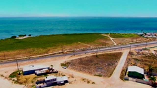 SAN CARLOS BCS MEXICO-2022: Coastal Road with Vehicle Moving Near Ocean