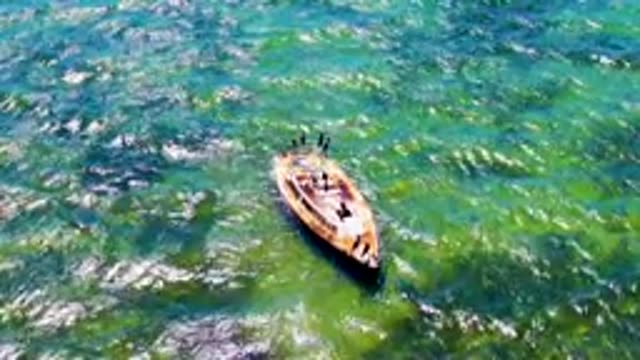 SAN CARLOS BCS MEXICO-2022: Boat with People Departing on Clear Turquoise Water