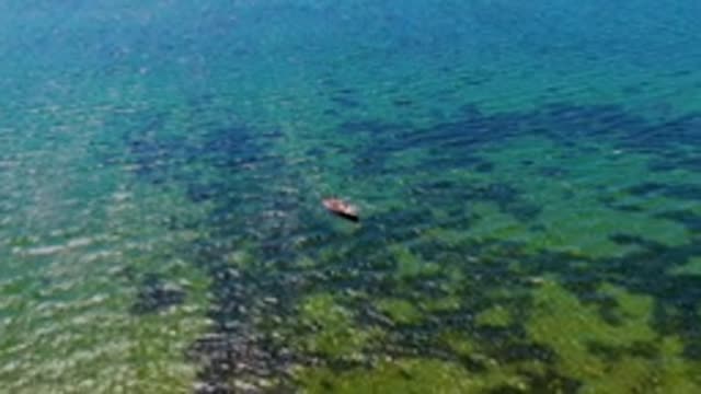 SAN CARLOS BCS MEXICO-2022: Small Boat Drifting in Shallow Clear Ocean Water