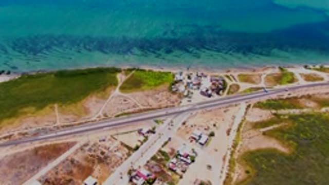 SAN CARLOS BCS MEXICO-2022: Coastal Highway with Moving Vehicles and Ocean