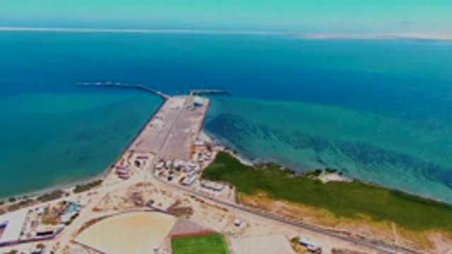 SAN CARLOS BCS MEXICO-2022: Coastal Causeway with Moving Vehicles and Clear Waters