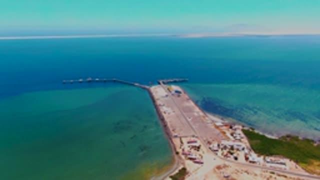 SAN CARLOS BCS MEXICO-2022: Coastal Dock Extending Into Turquoise Ocean Waters