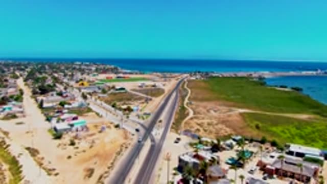 SAN CARLOS BCS MEXICO-2022: Coastal Highway with Moving Vehicles and Buildings