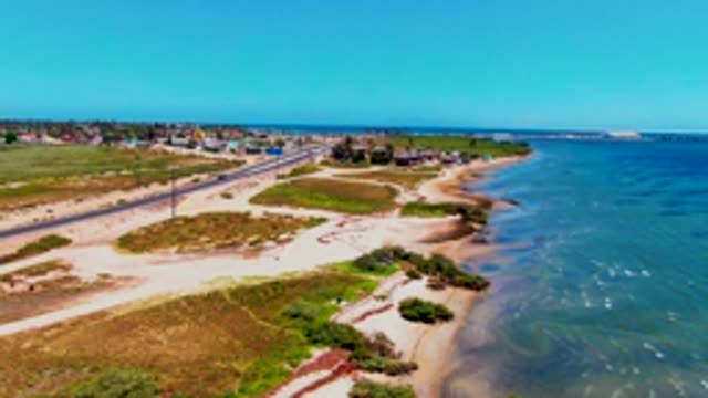 SAN CARLOS BCS MEXICO-2022: Coastal Road with Vehicles and Sandy Shore