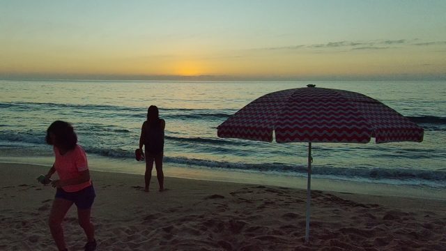SAN PANCHO NAYARIT MEXICO-2022: Two People on Beach at Sunset, One Walking Away