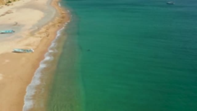 LOS FRAILES LOS CABOS BCS MEXICO-2022: Gentle Ocean Waves Along Sandy Shore with People