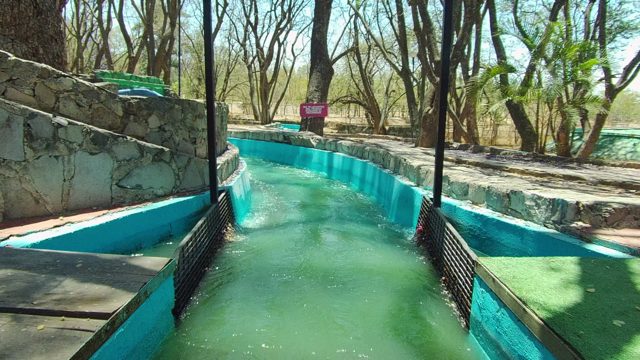 GUADALAJARA MEXICO-2022: Outdoor Water Slide with Flowing Green Water