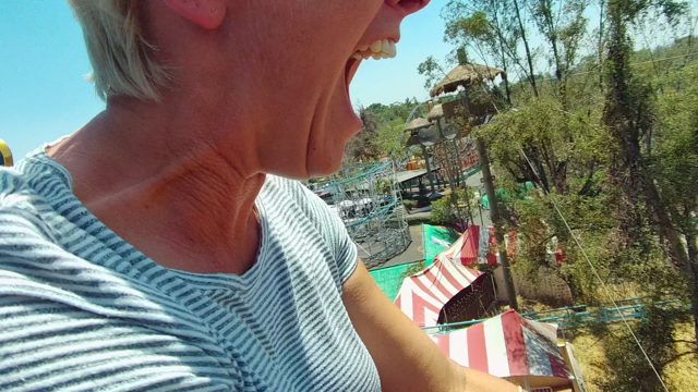 GUADALAJARA MEXICO-2022: Woman Riding Roller Coaster in Amusement Park