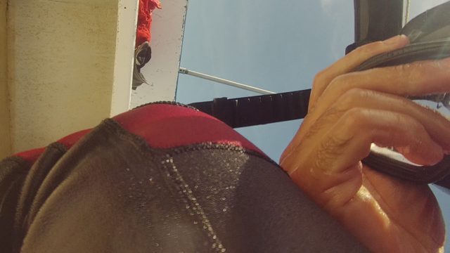 Hand Holding Device Near Red and Black Fabric