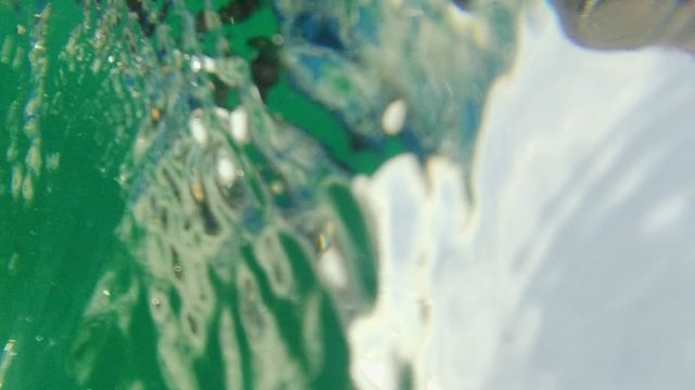 Swimmer Moving Through Clear Green Water