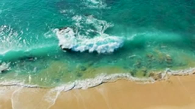 LA FORTUNA EAST CAPE BCS MEXICO-2022: Waves Crashing on Rocky Shore with Turquoise Water