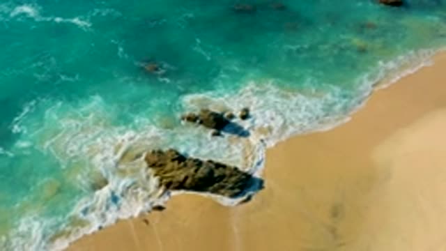 LA FORTUNA EAST CAPE BCS MEXICO-2022: Waves Crashing on Rocky Shore with Turquoise Water