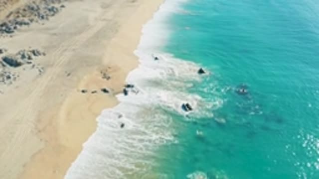 LA FORTUNA EAST CAPE BCS MEXICO-2022: Waves Crashing on Sandy Shore From Aerial View