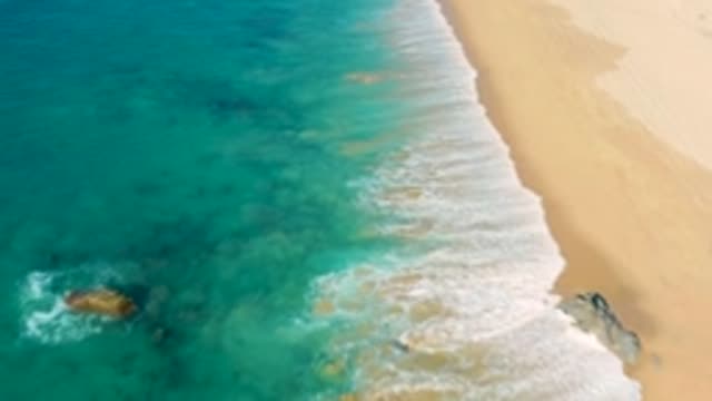 LA FORTUNA EAST CAPE BCS MEXICO-2022: Gentle Ocean Waves Rolling Onto Sandy Beach