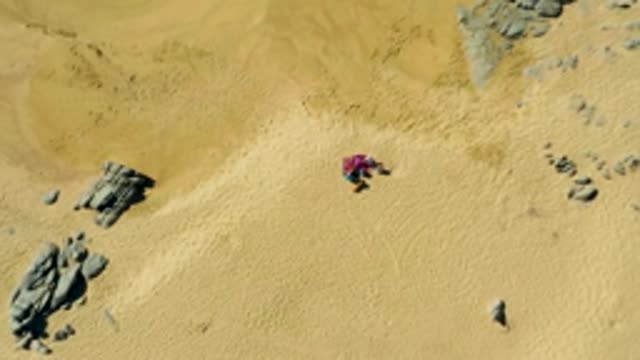LA FORTUNA EAST CAPE BCS MEXICO-2022: Person in Pink Clothing on Sandy Terrain with Rocks