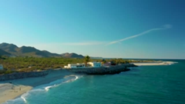 LAS BARRACAS EAST CAPE BCS MEXICO-2022: People Walking on a Sandy Beach with Ocean Waves