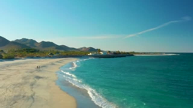 LAS BARRACAS EAST CAPE BCS MEXICO-2022: Gentle Ocean Waves Lapping Sandy Beach Shore