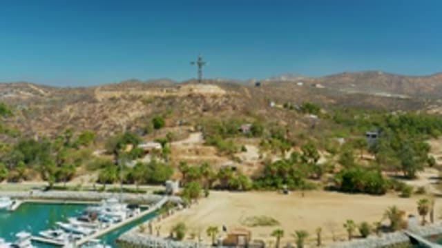 PUERTO LOS CABOS BCS MEXICO-2022: Hill with Cross and Marina in Aerial Transition