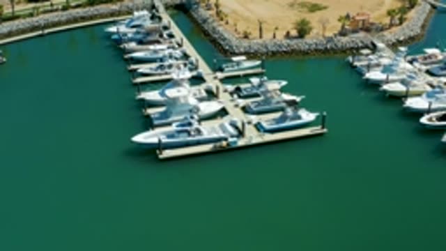 PUERTO LOS CABOS BCS MEXICO-2022: Boats Docked at Marina with Stone Breakwater