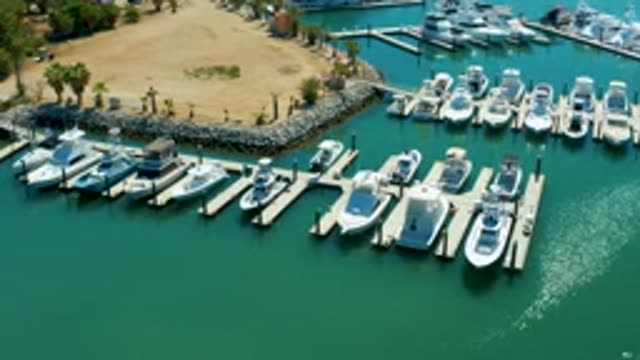PUERTO LOS CABOS BCS MEXICO-2022: Marina with a Boat Moving Through the Docks