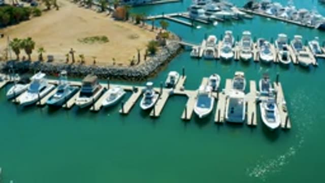 PUERTO LOS CABOS BCS MEXICO-2022: Marina with Docked Boats and Small Boat Moving
