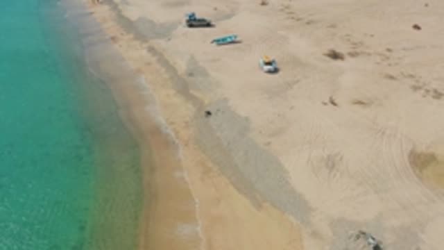 LOS FRAILES LOS CABOS BCS MEXICO-2022: Beach with Parked Vehicles and Ocean Shoreline