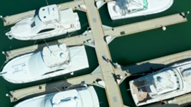 PUERTO LOS CABOS BCS MEXICO-2022: Yachts Docked at Marina with People Walking on Piers
