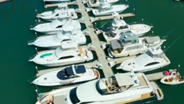 PUERTO LOS CABOS BCS MEXICO-2022: Yachts Docked at Marina As Small Boat Approaches