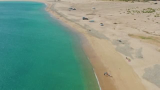 LOS FRAILES LOS CABOS BCS MEXICO-2022: Sandy Beach with Clear Turquoise Water and People