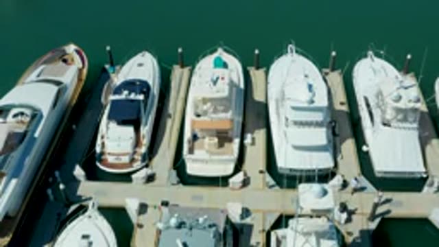 PUERTO LOS CABOS BCS MEXICO-2022: People Moving Along a Marina Dock with Docked Yachts