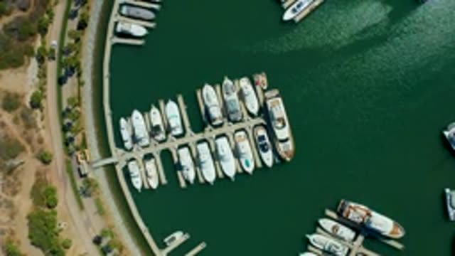 PUERTO LOS CABOS BCS MEXICO-2022: Marina with Docked Boats and Moving Car